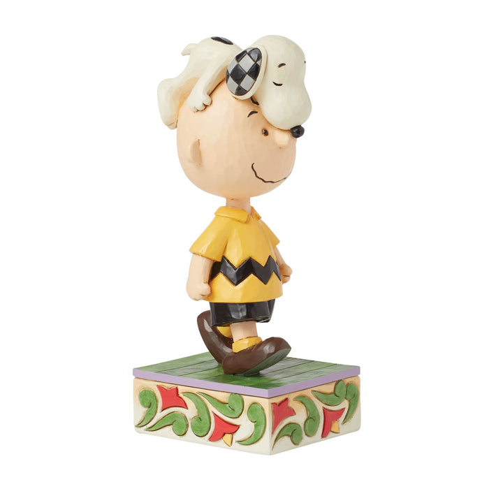 Snoopy on Charlie Brown's Head