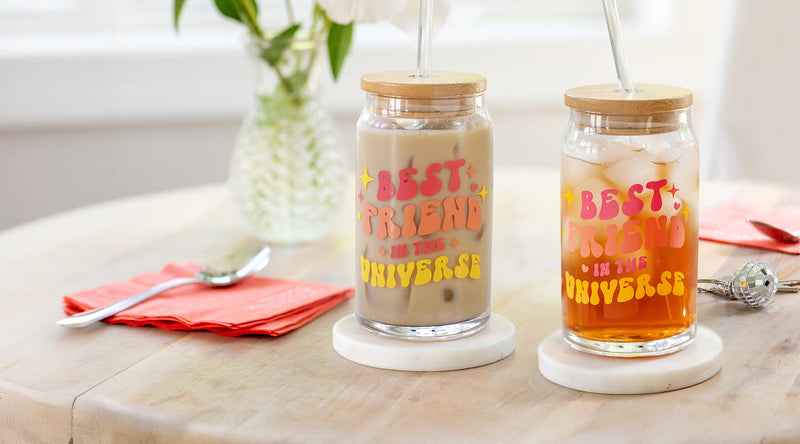 Two glass jars with 'Best Friends in the Universe' text on a wooden surface.