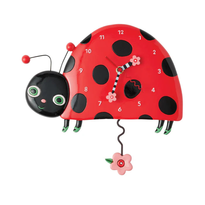 Red ladybug clock with black spots on a white background