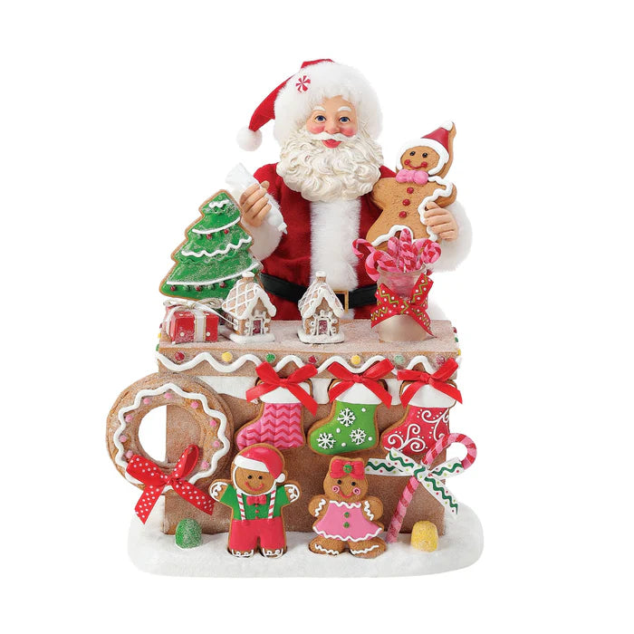 Decorative Christmas figure with Santa Claus and gingerbread cookies on a white background