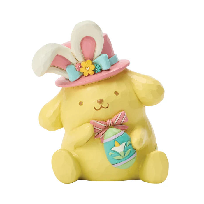 Yellow bunny figurine with Easter-themed accessories on a white background