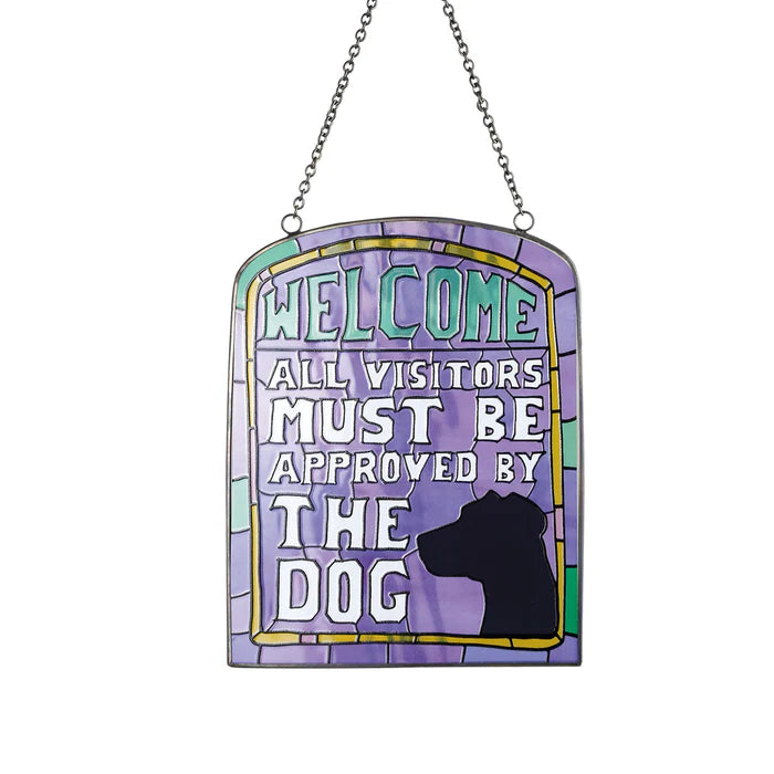 Decorative sign with 'Welcome, all visitors must be approved by the dog' text on a white background